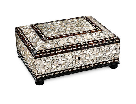 Rectangular box with ornate mother-of-pearl inlay in an abstract floral pattern framed by tortoiseshell, photographed on a white background and viewed from slightly above. 